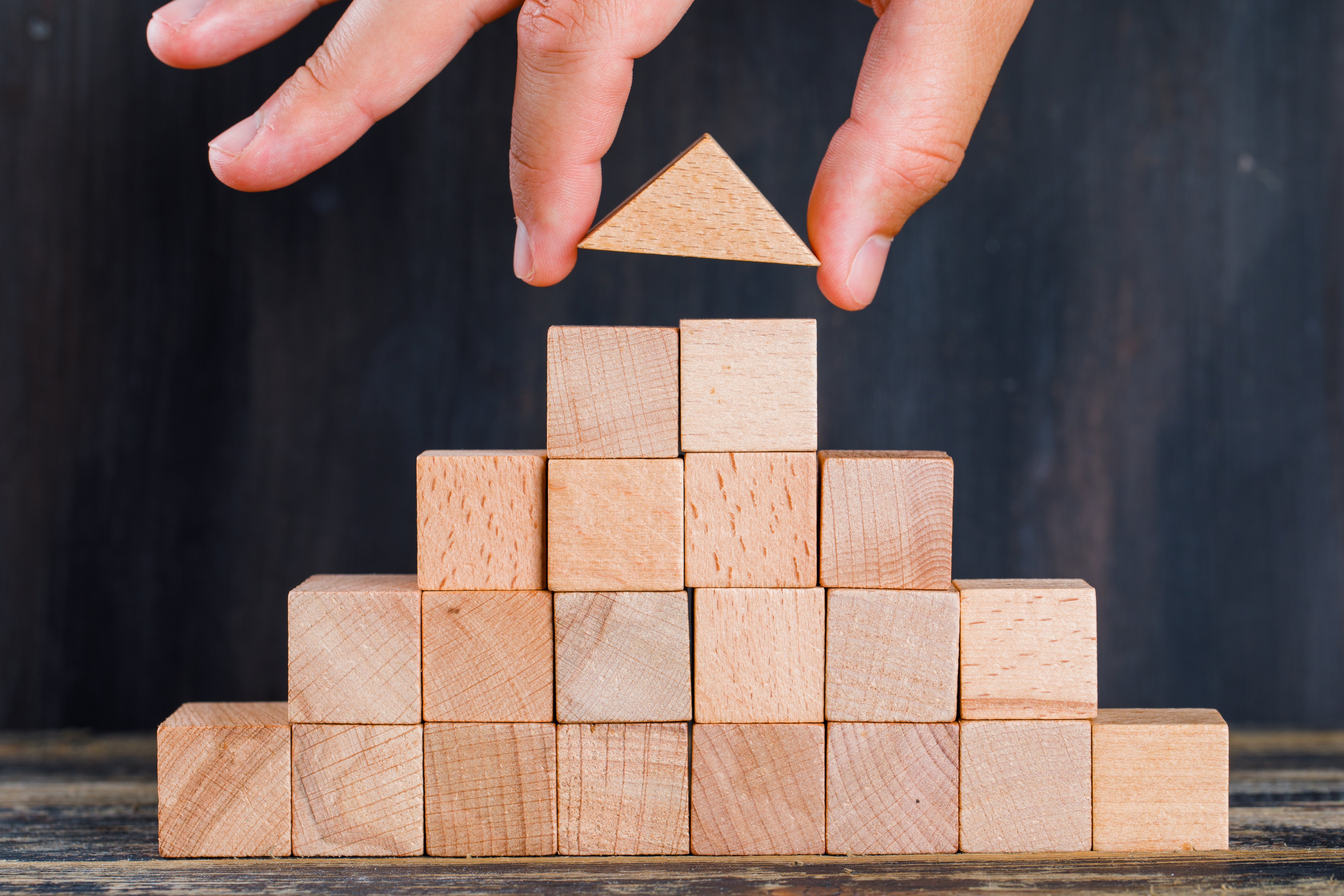 "https://www.freepik.com/free-photo/marketing-concept-wooden-dark-background-side-view-hand-arranging-wooden-block-as-stacking_9178652.htm#query=lego&position=37&from_view=search&track=sph&uuid=3bbf8799-7316-4022-8c6e-dfd042fa86c7"