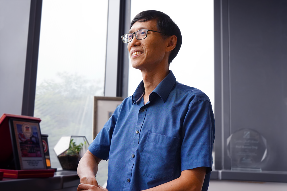 A photo of Marcus Ong an emergency physician and health services and systems research programme director at Duke-NUS  in his office looking out of the window