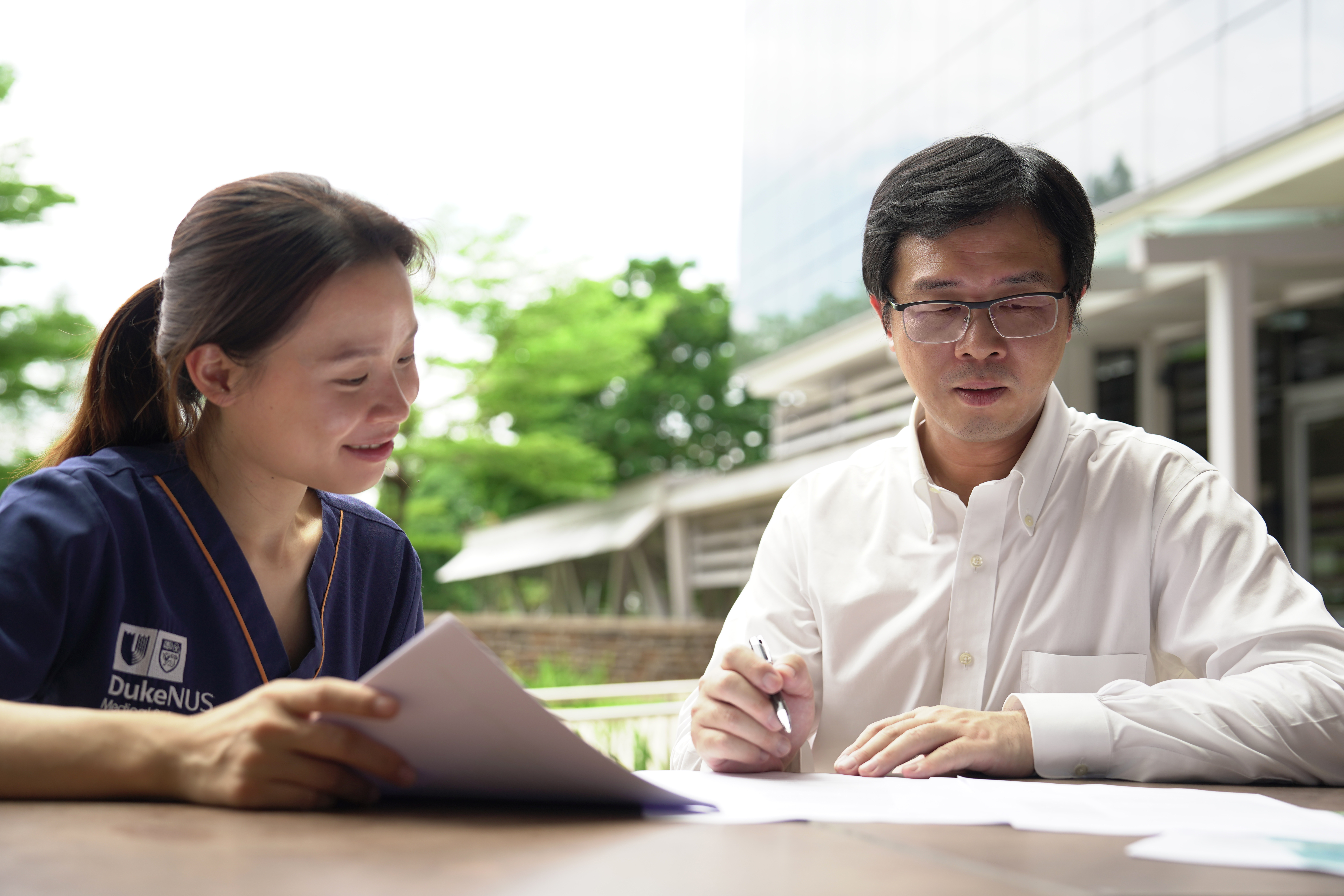 Yvonne Wong and Prof Liu Nan pore over some documents together.