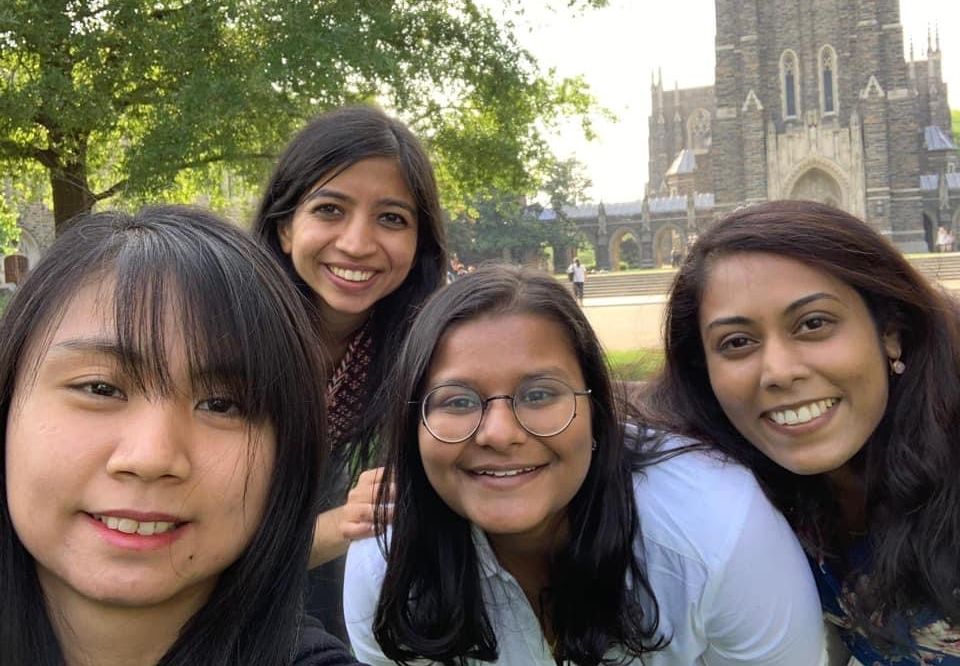 Four women who are all Duke-NUS Class of 2020 alumni in front of the Duke Chapel. They spent their third-year at Duke, Durham