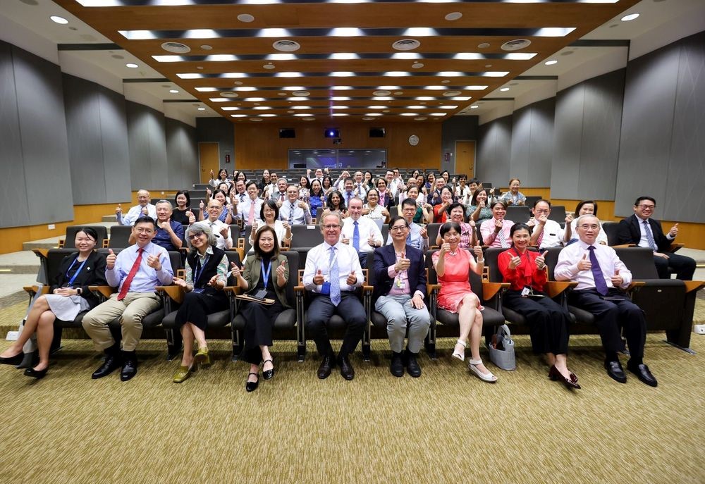 A group photo of people from Duke-NUS celebrating their faculty