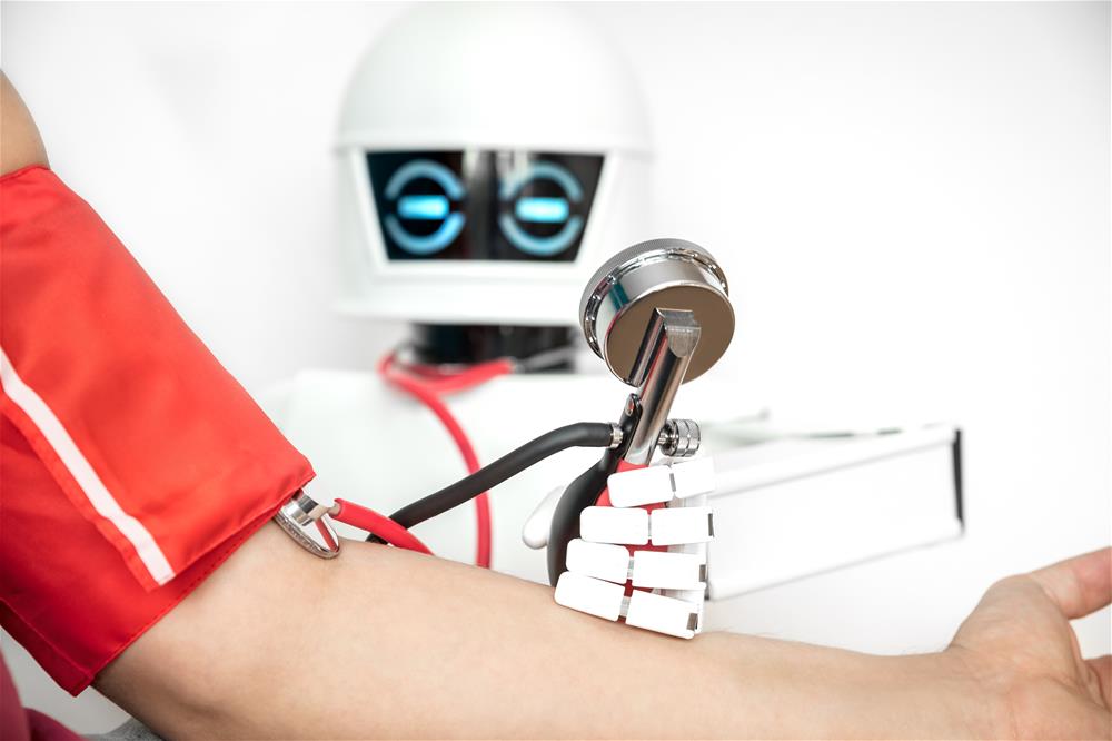 A robot takes the blood pressure of a patient