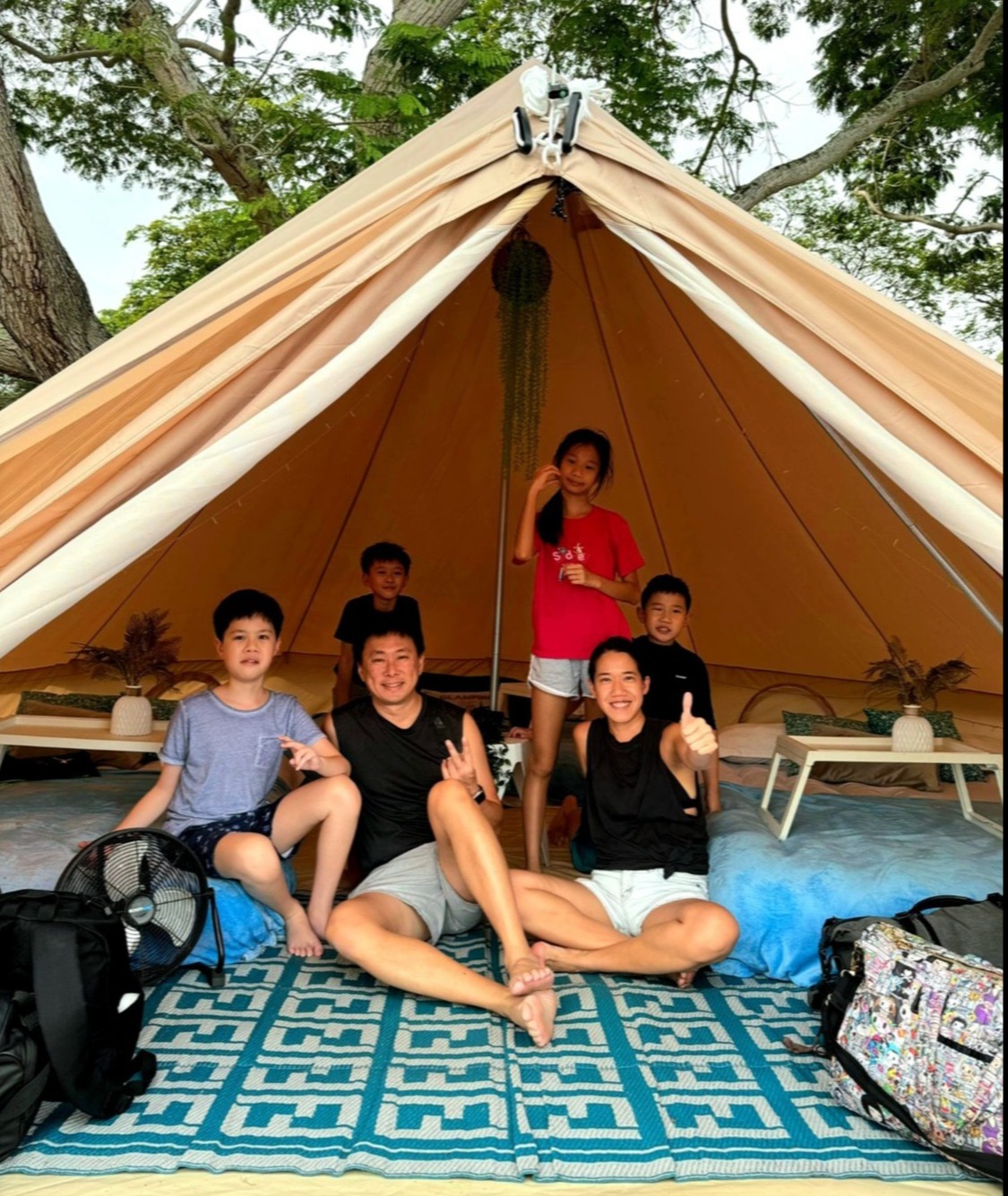 Spending time with the kids as much as I can, whether waiting with them for the school bus every morning or glamping at East Coast Park during the school holidays in November 2024 // Credit: Rena Dharmawan