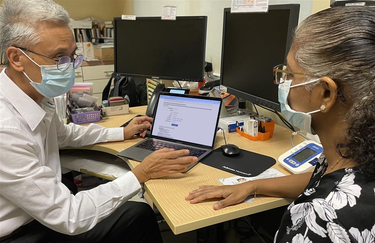 Clinical Associate Professor Tan Ngiap Chuan during a consultation with a patient // Credit: SingHealth Polyclinics