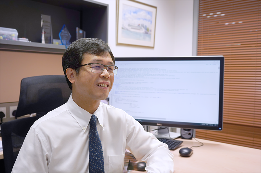 Chinese data scientist Liu Nan sits in front of his computer which displays the codes of one of AI programmes, AutoScore
