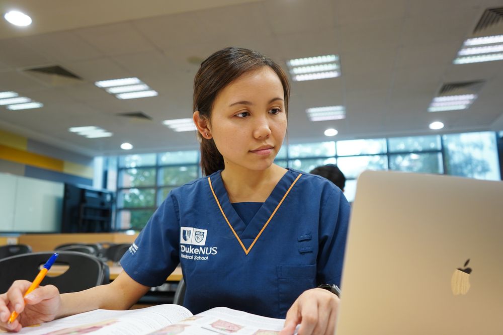 A female Duke-NUS medical student completes an assignment