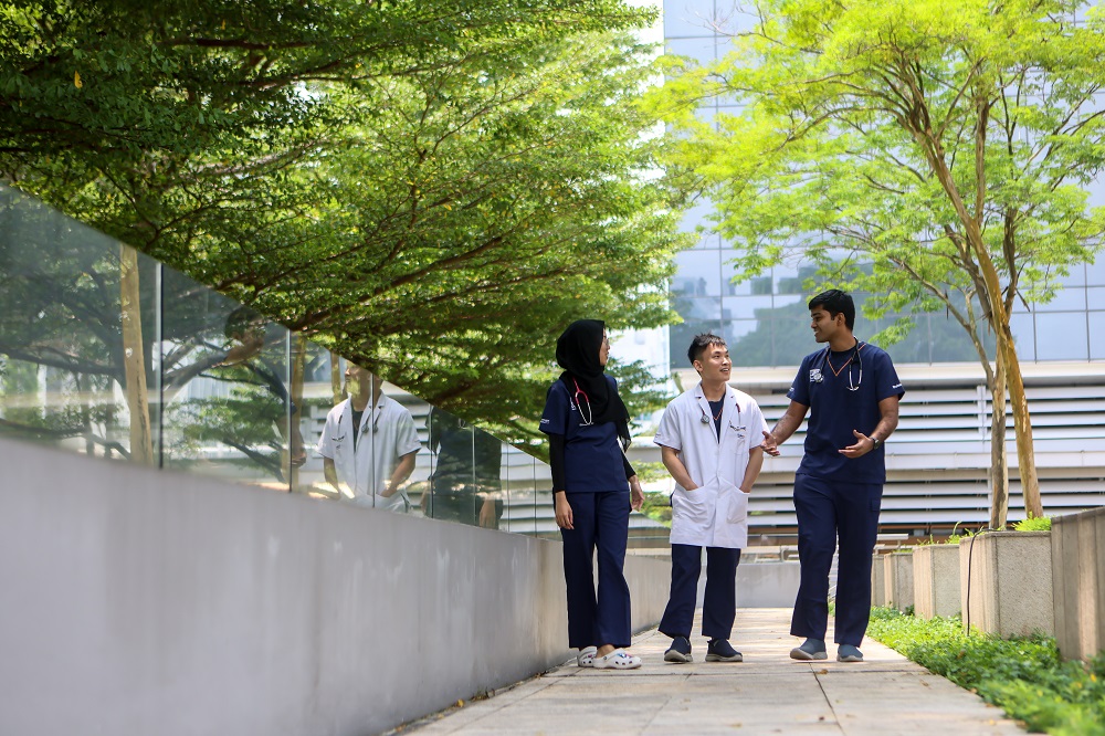 A group of three students walking outdoor