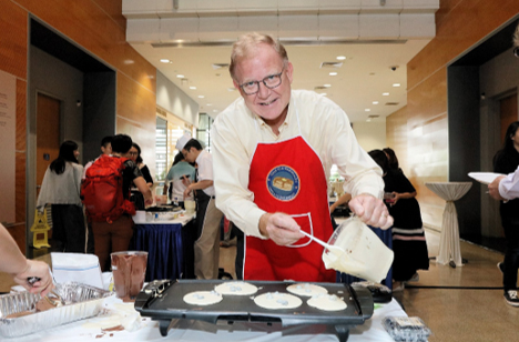 Patrick Casey taking part in the Deans’ annual pancake breakfast