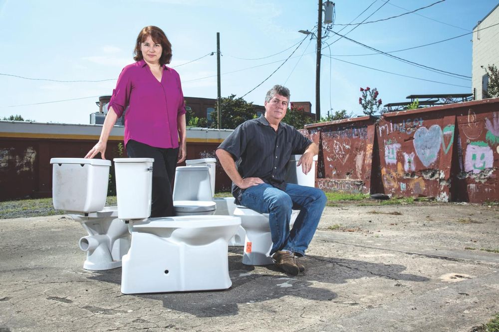 Two researchers with their novel toilet