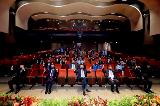 The audience in the auditorium gives their thumbs up in celebration of the Hall of Master Academic Clinicians 2022 inductees and the newly promoted and appointed clinical faculty