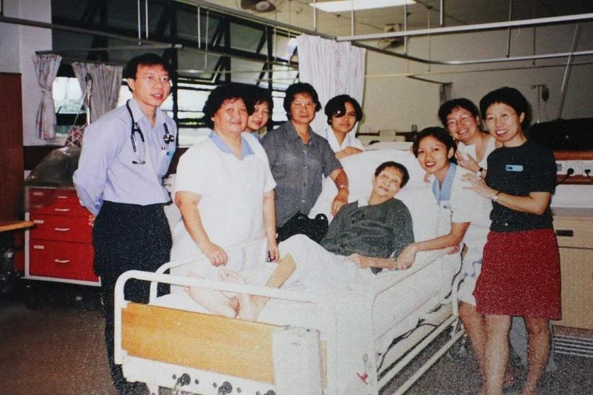 Assoc Prof Tan Boon Yeow (extreme left) with health workers and a patient at St Luke’s dementia ward.