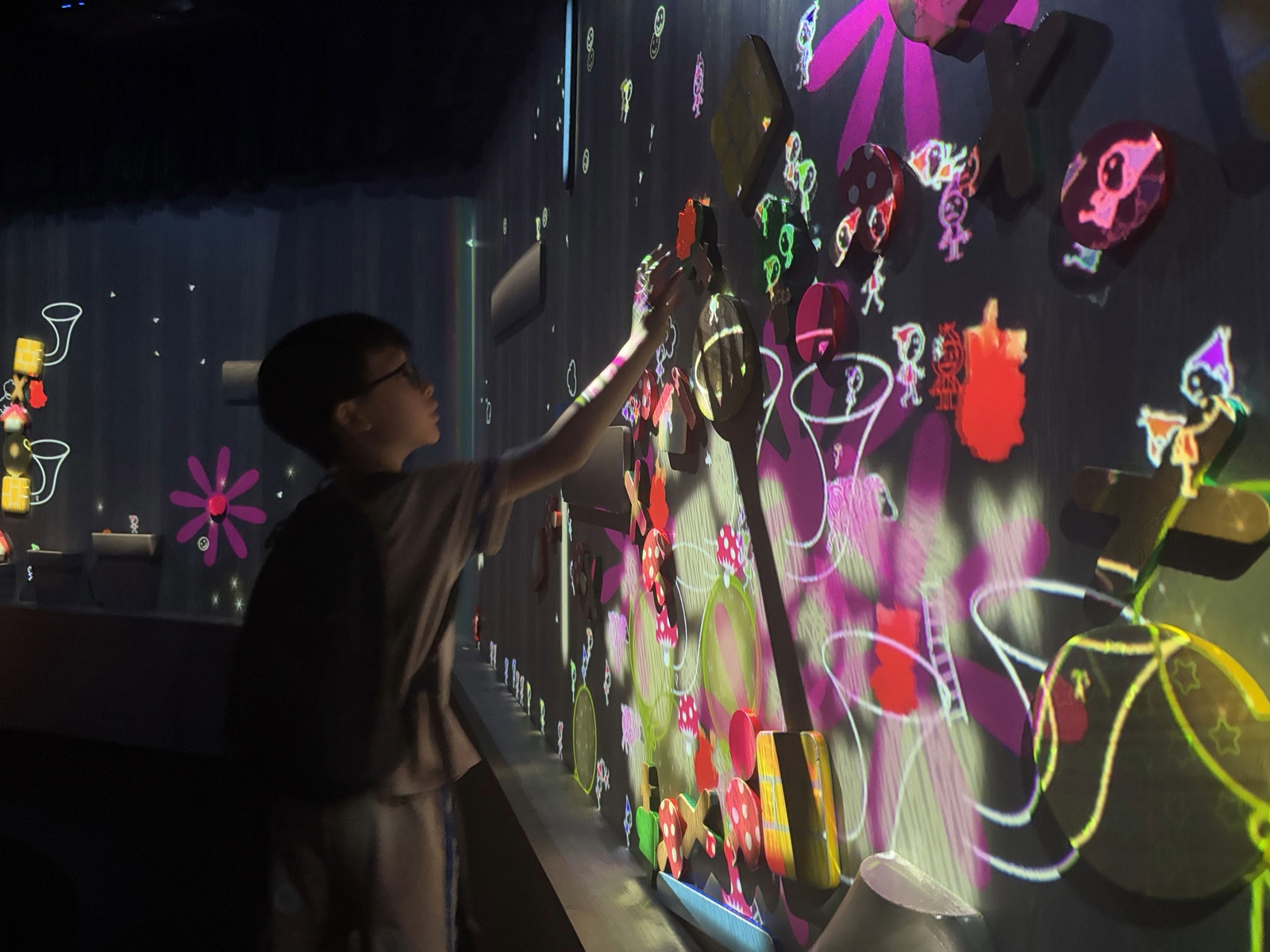 A camper interacts with an installation at the ArtScience Museum.
