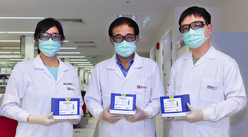 Resarch assistant Ong Xin Mei, Professor Wang Linfa, and research assistant Lim Beng Lee with the cPass test kits
