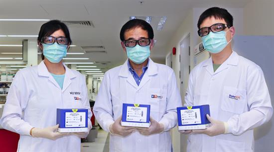 Resarch assistant Ong Xin Mei, Professor Wang Linfa, and research assistant Lim Beng Lee with the cPass test kits
