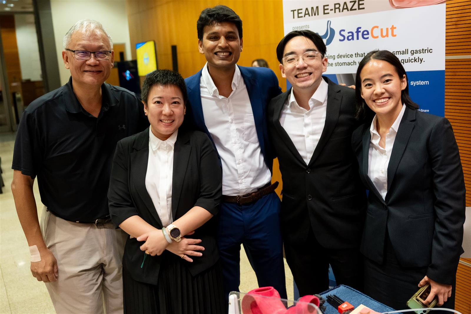 Team E-Raze poses with their innovation—SafeCutTM