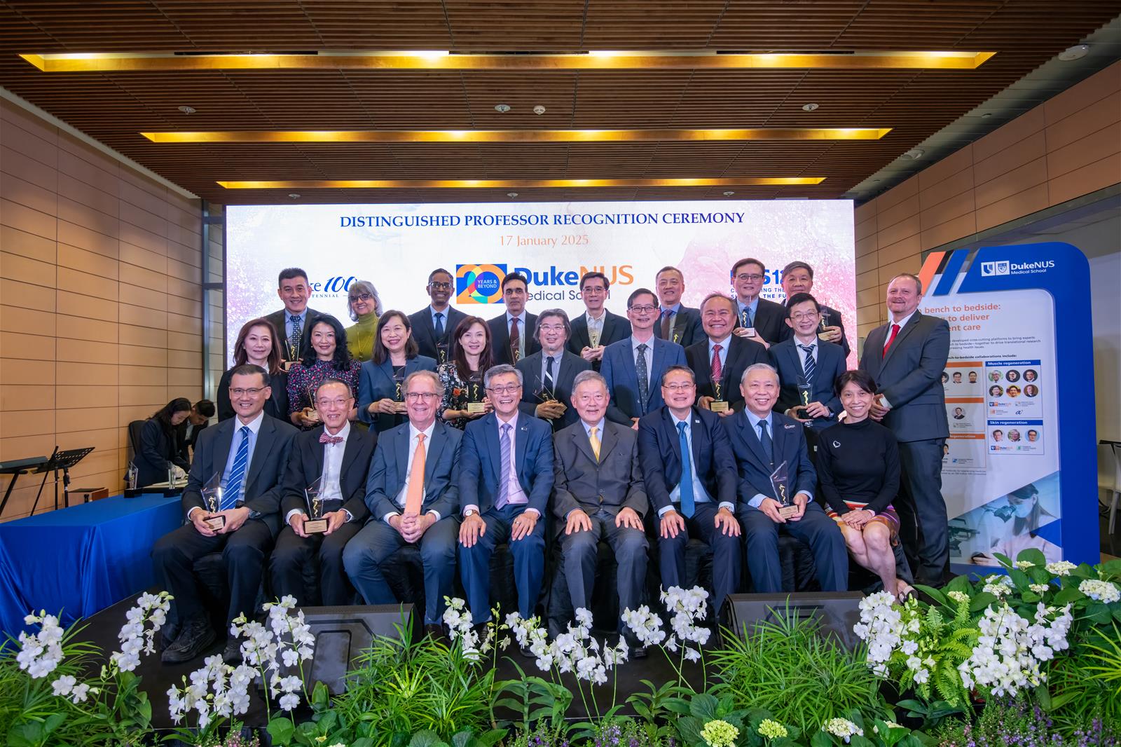 Distinguished professorship recipients, both past and present, share the stage for a group photo with senior leaders and stakeholders from Duke-NUS and SingHealth