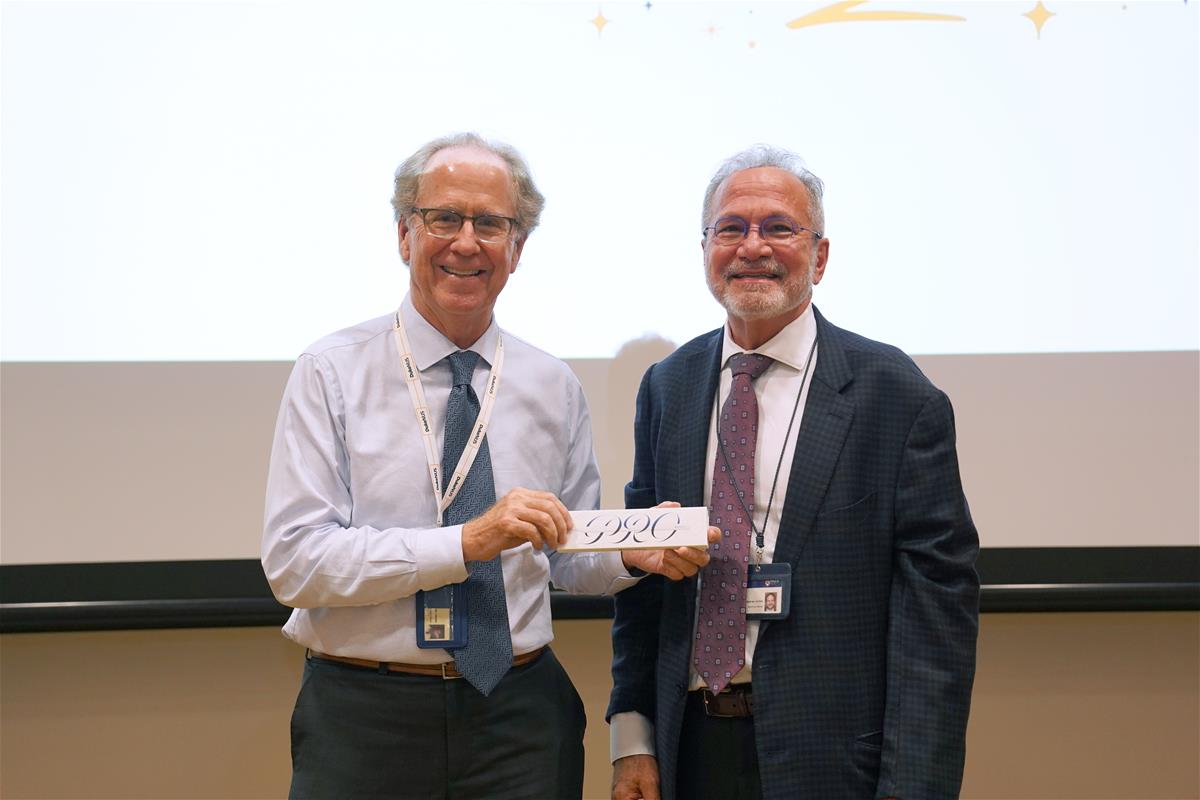 Dean Prof Thomas Coffman (left) presents Prof David Matchar (right) with a token of appreciation