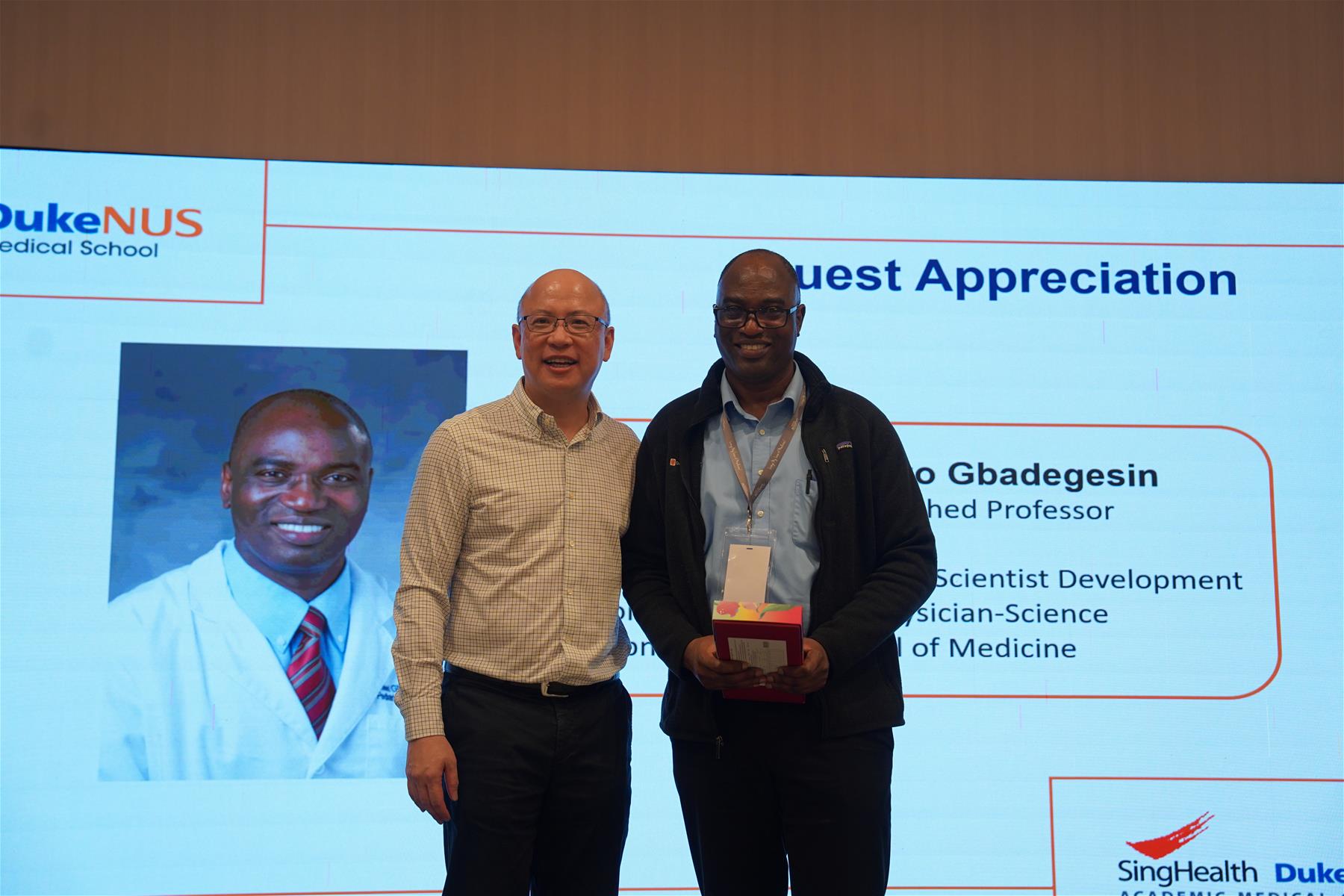 CCS+D director Prof Darren Lim presents a token of appreciation to special guest Duke Professor of Paediatrics Professor Rasheed Adebayo Gbadegesin.