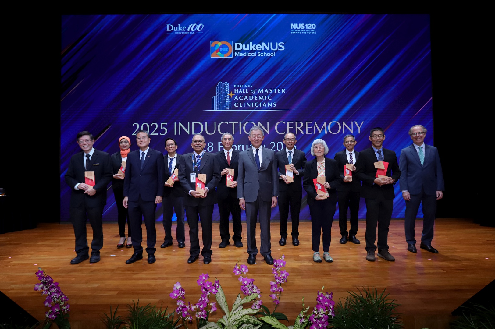 The newly inducted Master Academic Clinicians share a group photo with SingHealth Group CEO Professor Ng Wai Hoe (front left), Duke-NUS Governing Board Chair Mr Goh Yew Lin (front third from left) and Dean Coffman