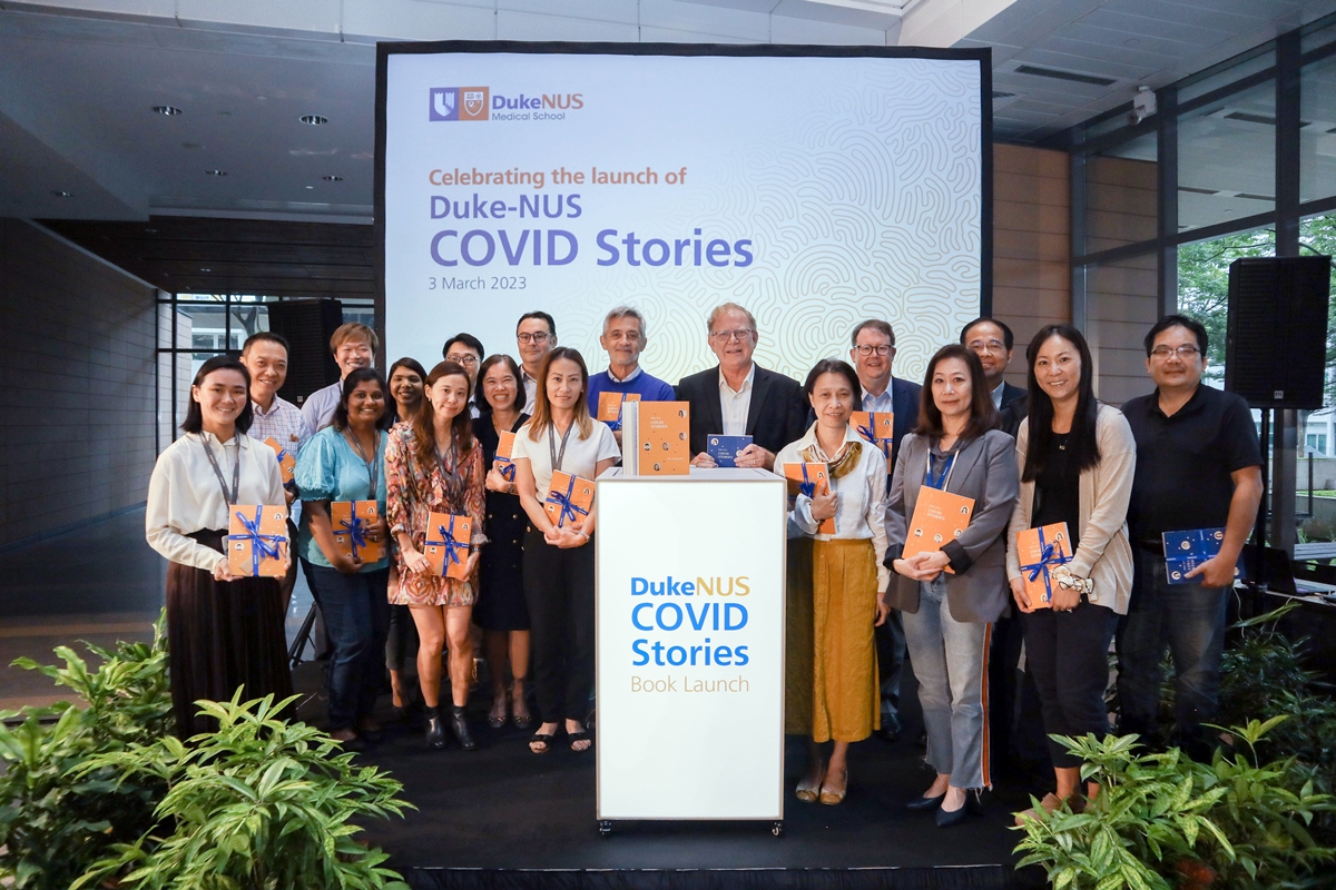 Duke-NUS senior management with the researchers, clinician-scientists and alumni featured in the book