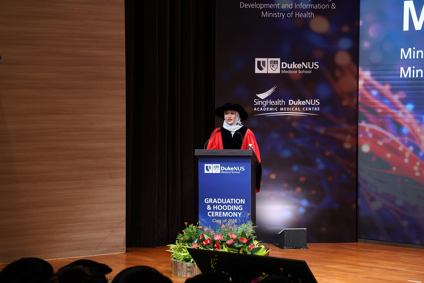 Minister of State, Ministry of Digital Development and Information & the Ministry of Health, Mdm Rahayu Mahzam addresses the Class of 2026.