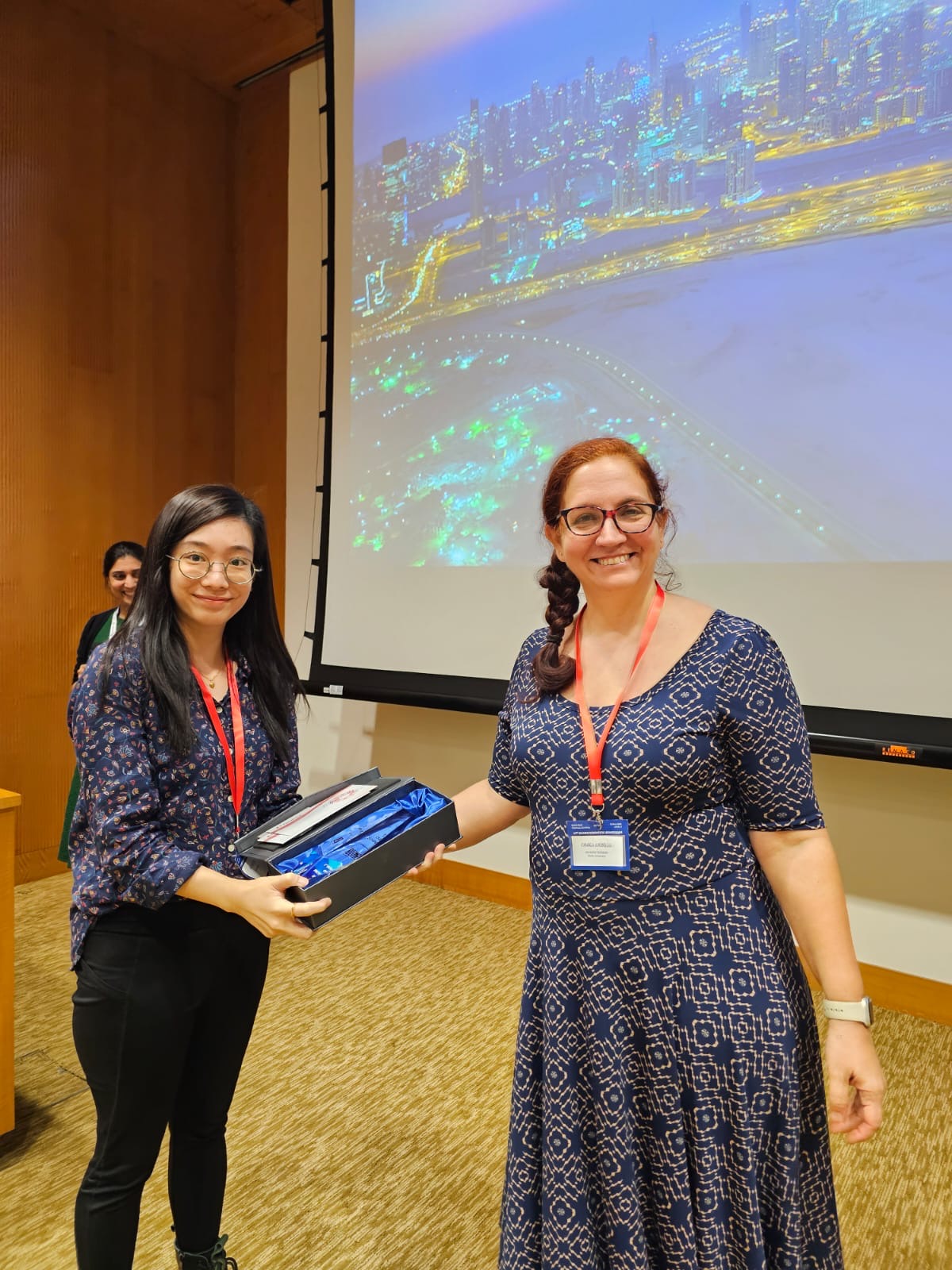 Nicole Lee (left) receiving her prize from keynote speaker Professor Cagla Eroglu.
