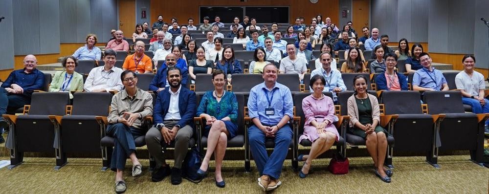 OIE group 1 A photo of a group of people sitting in a tiered auditorium
