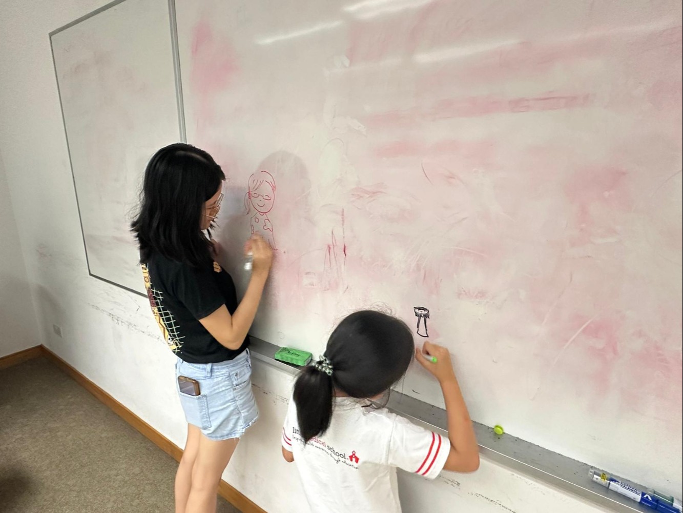 The campers, demonstrating their artistic ability by drawing Kexin