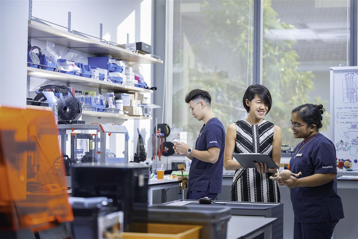 Assistant Professor Rena Dharmawan, pictured here mentoring students from the Duke-NUS Health Innovator Programme, received the Outstanding Young Alumni Award from NUS for her impact on innovation