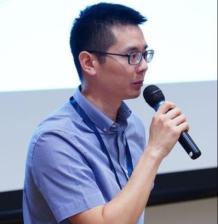 A Chinese man speaking into a microphone