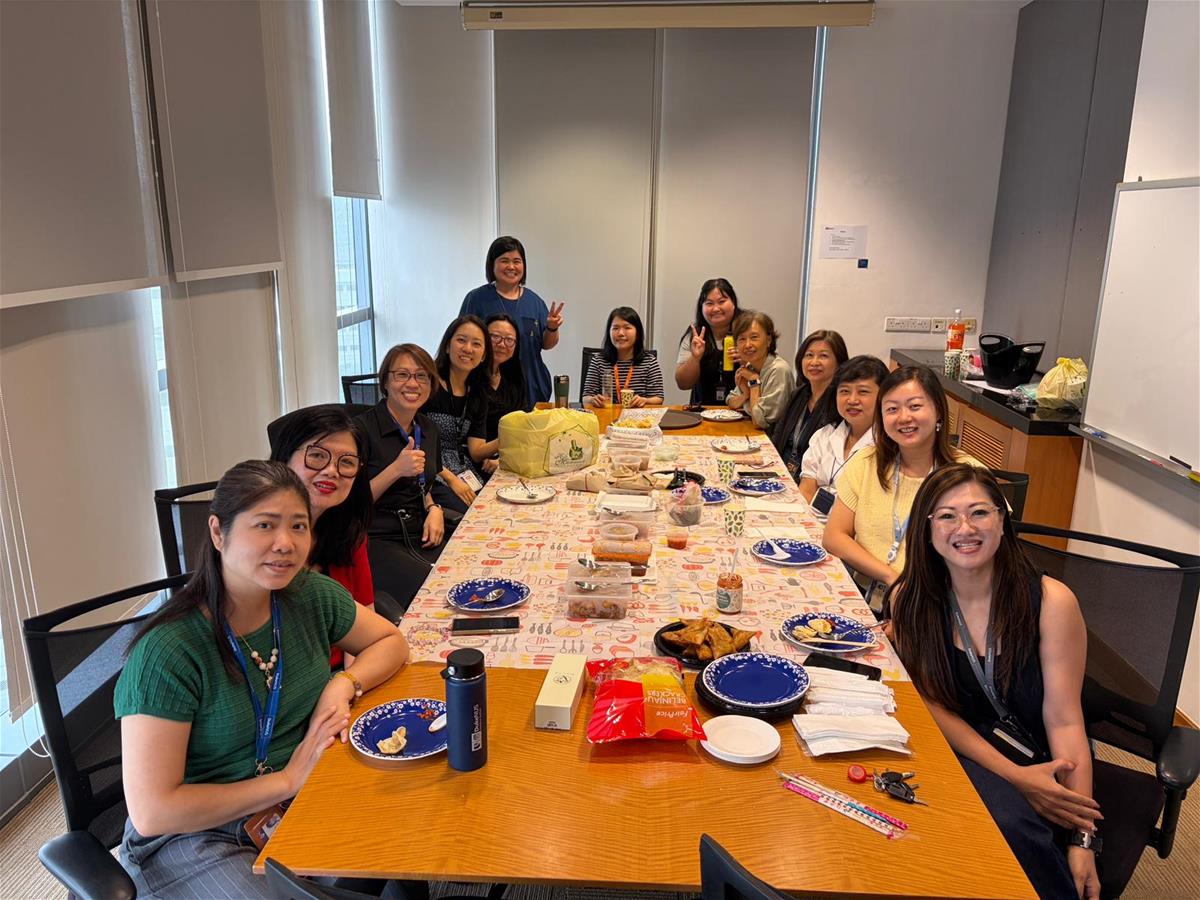 Mariel (left, fourth row up) celebrating a Christmas dinner with key administrators from various Duke-NUS departments
