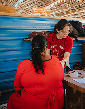 Duke-NUS medical student Laura Yang assisting with measuring blood pressure at a community health screening programme in Kilinochchi