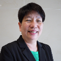 Photo of Ruth Lee smiling and wearing a black blazer and turquoise blouse